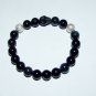 Men's 10 MM Black Onyx Stretch Bracelet With Howlite Skull and Silver Spheres 8.0"