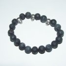 Men's 10 MM Black Lava Stretch Bracelet With Three Antique Silver-Tone Skulls 8.0"