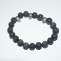 Men's 10 MM Black Lava Stretch Bracelet With Three Antique Silver-Tone Skulls 8.0"