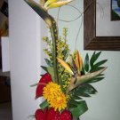 AN ELEGANT TROPICAL  SUNBURST  FLORAL ARRANGEMENT