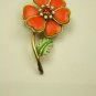 Fun bright orange Vintage pin with orange rhinestone center