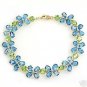DD-1599Y: 14K. GOLD TENNIS BRACELET W/NR . BLUE TOPAZ & PERIDOTS
