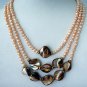 THREE STRAND CHAMPAGNE PEARL NECKLACE GOLD AND BRONZE ACCENTS