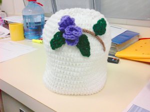 white hat with purple rose
