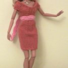 Orange knit dress with pink sash