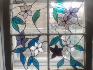 Old time wooden window frame with floral inserts