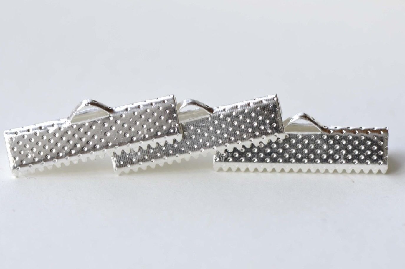 Silver Ribbon Ends Clamps Fasteners Clasps  25mm Set of 50 A8140