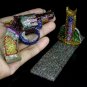 665CTS UNHEATED RHODOLITE GARNET, ZIRCON & SAPPHIRE GUN FIGURINE