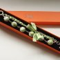 Apple green cotton beads and green satin ribbon bracelet