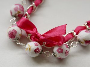 Cotton beads and pink satin ribbon bracelet