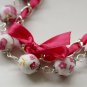 Cotton beads and pink satin ribbon bracelet