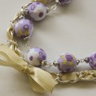 Violet cotton beads and yellow satin ribbon bracelet