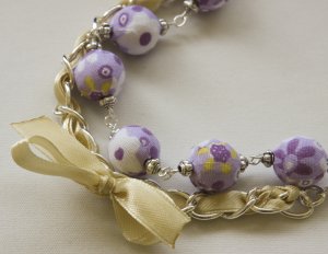 Violet cotton beads and yellow satin ribbon bracelet