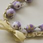 Violet cotton beads and yellow satin ribbon bracelet