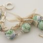 Light green floral cotton beads and beige satin ribbon bracelet