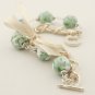 Light green floral cotton beads and beige satin ribbon bracelet