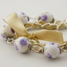 Violet cotton beads and eggshell satin ribbon bracelet