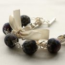Black floral cotton beads and beige satin ribbon bracelet