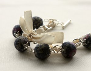 Black floral cotton beads and beige satin ribbon bracelet