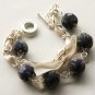 Black floral cotton beads and beige satin ribbon bracelet