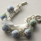 Blue cotton beads and white satin ribbon bracelet