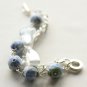 Blue cotton beads and white satin ribbon bracelet