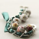 White floral fabric beads and emerald satin ribbon bracelet