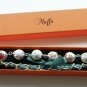 White floral fabric beads and emerald satin ribbon bracelet