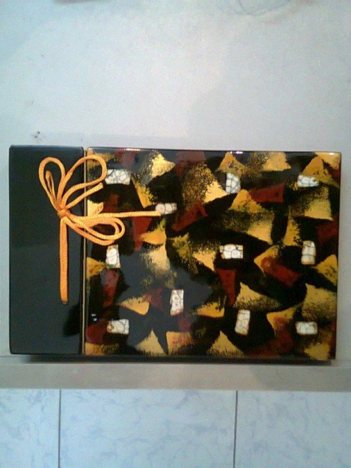 Lacquer album with inlaid egg