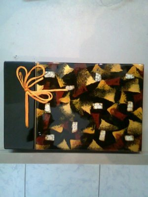 Lacquer album with inlaid egg