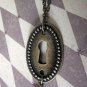 Alice in Wonderland: Down the Rabbit Hole Oval Keyhole Necklace