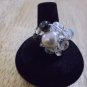 Metal glass pearl in the middle crystals and black beads around ring size 6