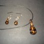 Clear glass genie bottle shaped necklace & earring set with gold and black swirls - eg10
