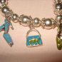 Silver stretch bracelet with enameled purse & shoe charms - eg23
