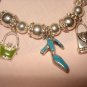 Silver stretch bracelet with enameled purse & shoe charms - eg23