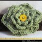 Crocheted headband with large green flower