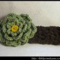 Crocheted headband with large green flower