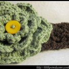 Crocheted headband with large green flower