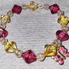 yellow clear and pink bracelet with butterfly