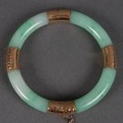 Certified Chinese jade bangle with hammered-gold mounts