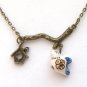 Antiqued Brass Branch Cage Porcelain Bird Necklace