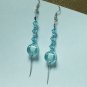 Silver tone earring dangle with blue crystal like bead