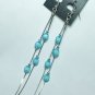 Silver tone earring with blue dangle bead