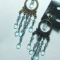 Copper tone earring with light blue crystal style dangle