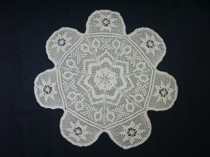 Hand crocheted ecru rainbow star doily.
