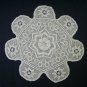 Hand crocheted ecru rainbow star doily.