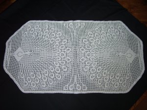 White handmade crocheted tablecloth with peacocks