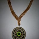 Embellished Gold circle pendant on a gold and copper crocheted necklace
