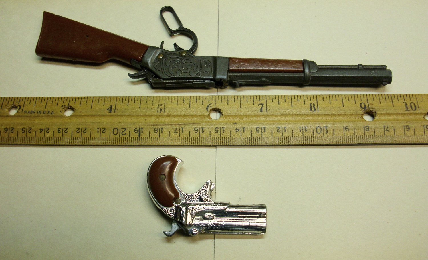 Miniature toy guns made of metal and plastic both with moving parts.