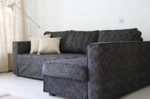 IKEA Manstad Corner Sofa-bed with storage Custom slipcover in Nomad Black.